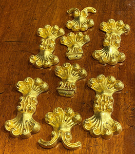 A set of Eight Lead Gold Leaf Appliqués