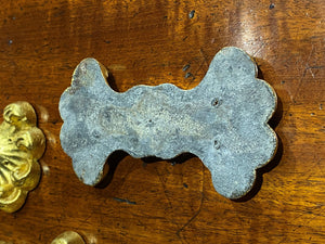 A set of Eight Lead Gold Leaf Appliqués