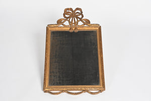 French Wall Mirror With Exceptional Foxed Plate And Cheeky Swag Detail.