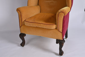 A Very Smart Wingback Armchair With Ball And Claw Feet And Brass Castors
