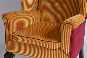 A Very Smart Wingback Armchair With Ball And Claw Feet And Brass Castors