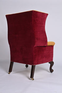 A Very Smart Wingback Armchair With Ball And Claw Feet And Brass Castors